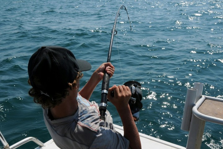 a man standing next to a body of water