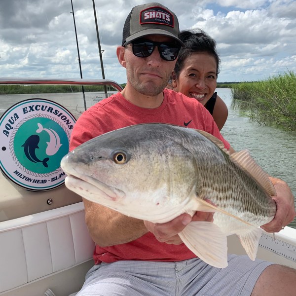 a person holding a fish