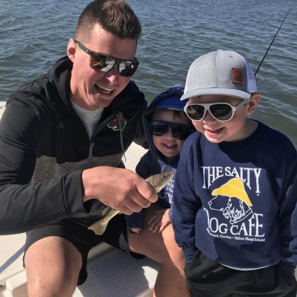 a couple of people that are sitting on a boat in the water