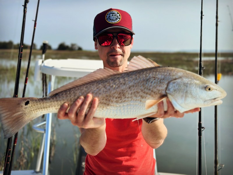 a man holding a fish